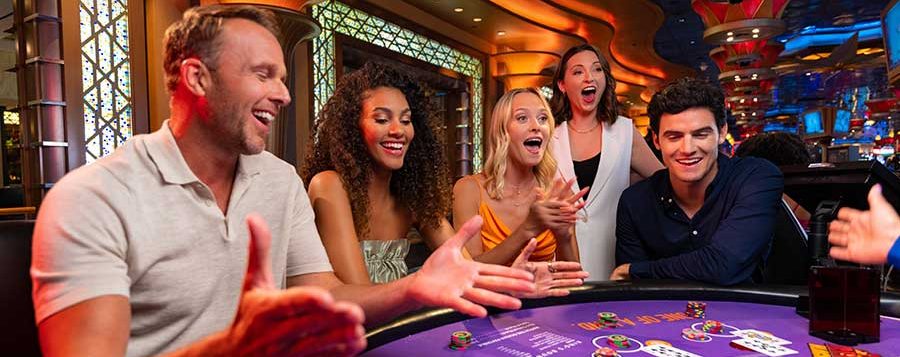 Happy Group Of Adults Gambling At Craps Table Stock Photo