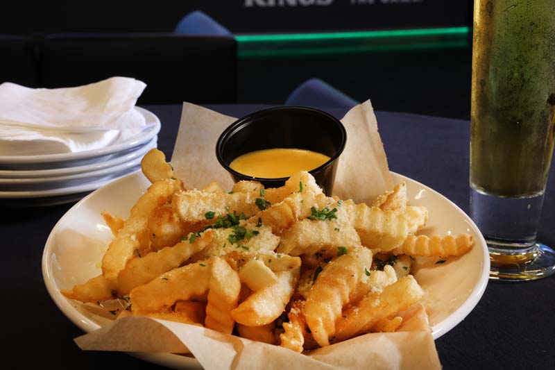 french fries and a glass of beer - DraftKings Sportsbook dining at Resorts AC